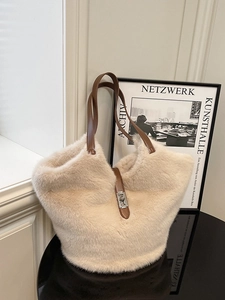 Furry cream tote bag with leather handles and metallic twist lock for winter outfits