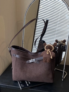 Retro coffee faux suede tote bag with bear charm and silver twist lock on dark table