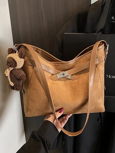 Vintage brown suede tote bag with metal twist lock and cute knitted bear charm accessory