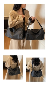 Detail of black large capacity multi-layer crossbody bag with waterproof nylon texture
