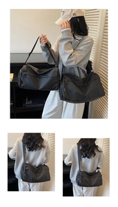 Detail of black multi-layered crossbody bag with adjustable wide straps and large capacity