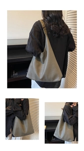 Detail of dark olive woven hobo shoulder bag showing large capacity and texture