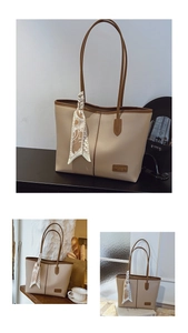Detail of khaki tote bag with fashion leather tag and decorative printed silk scarf