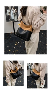 Detail view of large tote bag with brown suede and black leather patchwork design