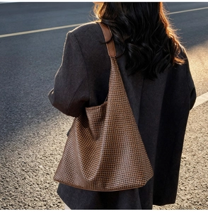 Detailed view of brown woven tote bag texture in sunset light during street shoot