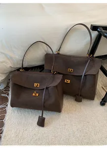 Detail of deep brown suede tote bags with golden twist locks in two sizes