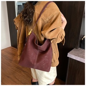 Deep burgundy frosted leather hobo bag with white stitching and gold hardware detail
