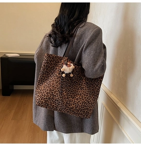 Close-up of leopard print canvas tote bag featuring a cute plush bear charm detail