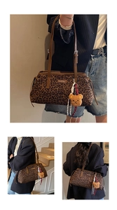 Detailed view of leopard print shoulder bag with fashion metallic logo and bear charm