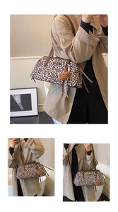 Detail of leopard print shoulder bag featuring brown leather trim and plush bear charm