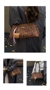 Detail of leopard print shoulder bag with plush bear charm and striped scarf accessory