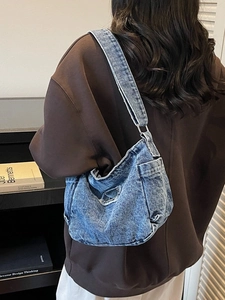 Retro wash blue denim tote bag with multiple pockets and wide shoulder strap