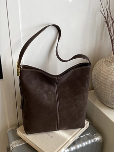 Retro coffee matte bucket bag with white contrast stitching and gold metal hardware