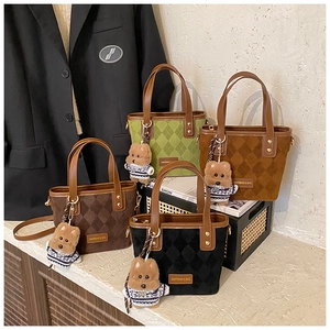 Macro shot of quilted suede bucket bags in four colors with cute teddy bear charms
