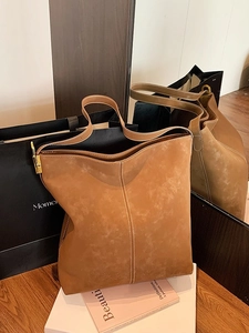 Retro brown oversized suede bucket bag with adjustable leather strap and gold buckle detail
