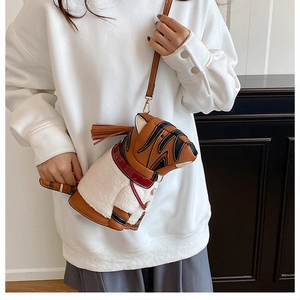 Detail showing plush animal tiger crossbody bag with brown lychee grain PU leather