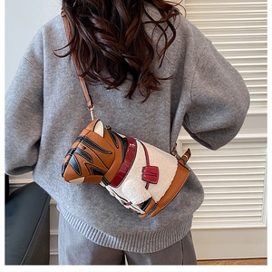 Rear view of a model wearing a cute dog-shaped crossbody bag made of faux fur and PU leather
