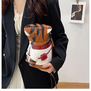 Detail shot of creative tiger-shaped shoulder bag featuring plush vest and lychee pattern