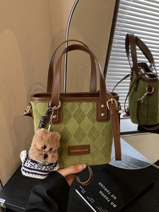 Retro patchwork bucket bag in green suede with brown leather trim and puppy pendant