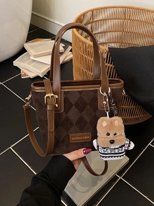 Brown quilted matte bucket bag with leather handles and cute plush bear charm