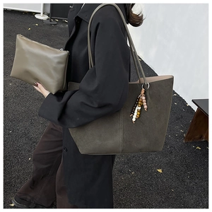 Detail of olive green suede tote bag with detachable pouch and colorful wooden beads