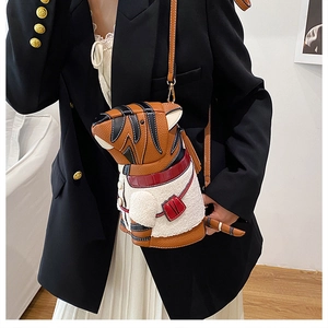 Detailed view of tiger-shaped crossbody bag with faux shearling and brown leather texture