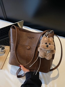 Brown vintage faux leather tote bag with round buckle and cute plush dog pendant