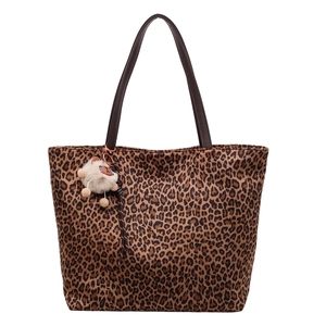 Chic leopard print tote bag with brown straps and white plush animal charm in 2025 style
