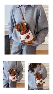 Detailed view of the tiger-shaped crossbody bag featuring faux shearling and orange leather