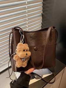 Deep brown large tote bag with top handle and cute plush dog pendant accessory