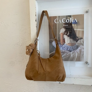 Détail du sac cabas en cuir PU marron avec couture et pendentif d'ours mignon