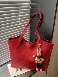 Retro red embossed leather tote bag with a cute plush bunny pendant and zipper closure