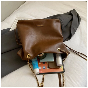 Interior view of large leather tote bag showing spacious capacity for tablet and cosmetics