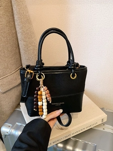 Vintage black patchwork bucket bag with round handles and tassel charm for women