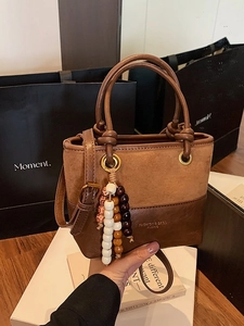 Retro patchwork bucket bag in caramel brown suede and leather with beaded charm