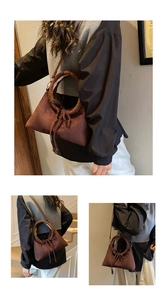 Detail of coffee brown suede tote bag with plush circular handles and drawstring accent