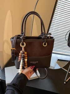 Vintage brown leather patchwork bucket bag with colorful beaded tassel and top handles