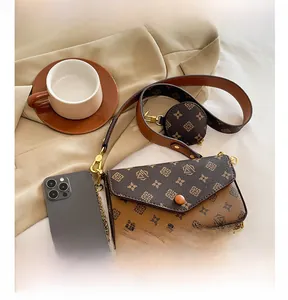 Detailed view of vintage brown monogram bag with small coin purse and gold chain