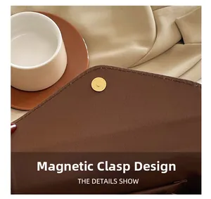 Detail view of the secure magnetic closure and inner pocket on a brown leather baguette bag