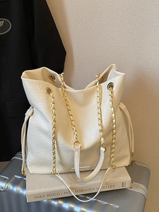 Chic cream white bucket tote bag with gold chain straps and soft leather texture