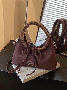 Brown matte tote bag with fuzzy shearling handle and bow detail on aesthetic background