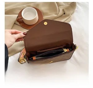 Detail showing internal compartment with zipper pocket in vintage brown pattern bag