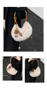 Detail of plush faux fur tote with wooden beads and monster charm on black coat
