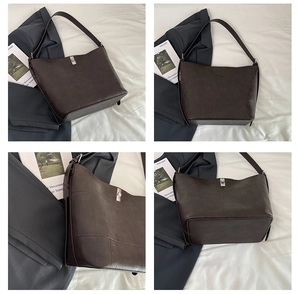 Detail view of dark coffee tote bag featuring silver buckle and textured faux leather