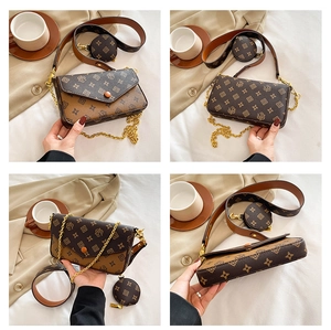 Detail view of vintage patterned crossbody bag with wide strap and coin purse attachment