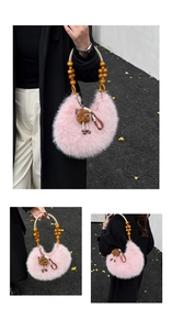 Detail of pink plush handbag with wooden bead handles and cute brown doll pendant