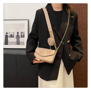 Close-up of beige monogram embossed three-in-one crossbody bag with round coin purse