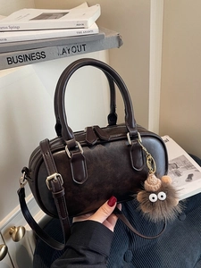 Retro dark brown Boston handbag with double handles and cute plush monster charm