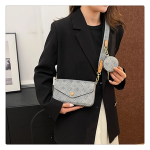 Detailed side view of grey monogram 3-in-1 crossbody bag with a wide strap on a model