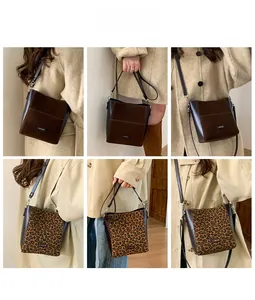Detail view of retro leopard print and brown suede bucket bags with adjustable straps